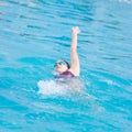 Woman in goggles swimming back crawl style Royalty Free Stock Photo