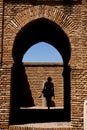 Woman going through the gateway in Alcazaba castle
