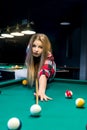 Woman going hit a ball with cue in billiard Royalty Free Stock Photo