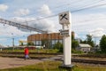 Woman is going next to kilometer pillar of The Road of Life. St Petersburg