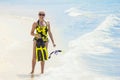 Woman going snorkeling while on a tropical vacation