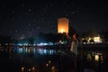 A woman going to release a lantern on a bamboo bridge beside the Ping River during Chiang Mai lantern festival