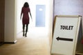 Woman going to toilet Royalty Free Stock Photo
