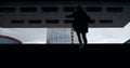 Woman going up stairs from dark underground metro station in city centre. Royalty Free Stock Photo