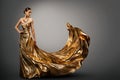 Woman Gold Dress, Fashion Model in Long Waving Gown, Young Girl Beauty Royalty Free Stock Photo