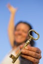 Woman gold key in hand blue sky Royalty Free Stock Photo