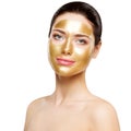 Woman Gold Mask, Beautiful Model with Golden Facial Skin Cosmetic, Beauty Skincare and Treatment Royalty Free Stock Photo