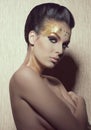 Woman with golden artistic make-up