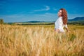 Woman on golden cereal field in summer Royalty Free Stock Photo