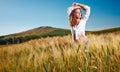 Woman on golden cereal field in summer Royalty Free Stock Photo