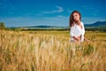 Woman on golden cereal field in summer Royalty Free Stock Photo