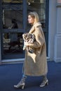 Woman with golden coat and shoes before Etro fashion show, Milan Fashion Week street style
