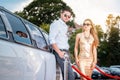 Woman and man leaning against a limo car Royalty Free Stock Photo