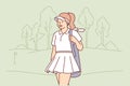 Woman with golf clubs walks around court and looks into distance with smile, anticipating good game Royalty Free Stock Photo