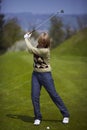 Woman on the golf course preparing for a swing Royalty Free Stock Photo