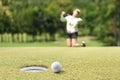 Woman golfer feeling disappointed after a putted golf ball missed Royalty Free Stock Photo