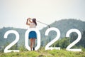 Woman golfer finished golf swing. Beginning and start of the new year 2022, goals and plans for the next year Royalty Free Stock Photo