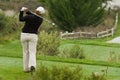 Woman golfer swinging driver on tee box Royalty Free Stock Photo