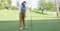 Woman golfer about to sink her putt Royalty Free Stock Photo