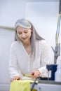 Woman in good mood removing stain from fabric