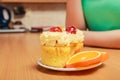 Woman with gourmet cream cake cookie and orange Royalty Free Stock Photo