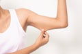 Woman grabbing skin on her upper arm with the drawing arrows. Royalty Free Stock Photo