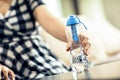 Woman grabs the bottle of filtered water Royalty Free Stock Photo