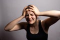 The woman grabs her head with her hands and gets angry. Family quarrels, panic attacks and fears, rage and anger, headache and