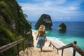 A woman gracefully descends a wooden staircase, leading her to the beautiful sandy beach, A woman enjoying the view at the beach