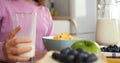 Woman gracefully pouring milk into cereal cinematic slow motion start of family breakfast Cereal is centerpiece of Royalty Free Stock Photo