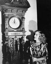 Woman with grandfather clock at midnight Royalty Free Stock Photo