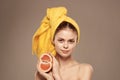 Woman with grapefruit in her hand clean skin bare shoulders spa health treatments Royalty Free Stock Photo