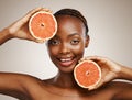 Woman, grapefruit and portrait of beauty in studio for vitamin c, vegan cosmetics and glow on brown background. Face