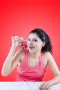 Woman with grapes on red background Royalty Free Stock Photo