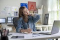 Woman graphic designer businesswoman feeling pain in neck after sitting at the table with laptop. Royalty Free Stock Photo