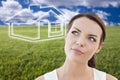 Woman and Grass Field with Ghosted House Figure Behind Royalty Free Stock Photo