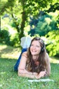 Woman on grass in park reading Royalty Free Stock Photo