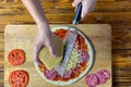 Woman is grating cheese for Pepperoni pizza Royalty Free Stock Photo