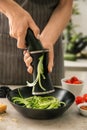 Woman grating zucchini in kitchen Royalty Free Stock Photo