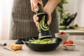 Woman grating zucchini in kitchen Royalty Free Stock Photo