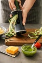 Woman grating zucchini in kitchen Royalty Free Stock Photo