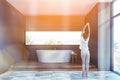 Woman in gray bathroom interior Royalty Free Stock Photo