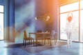 Woman in gray dining room interior Royalty Free Stock Photo