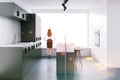 Woman in gray loft kitchen with a bar, side view Royalty Free Stock Photo