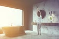 Woman in gray and white marble bathroom corner Royalty Free Stock Photo