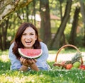 Woman in a great mood having a slice of a watermelon