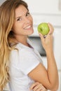 woman with green apple at home