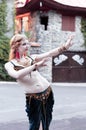 Woman in green belly dance costume with outstretched hands looking away Royalty Free Stock Photo