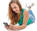 woman in green casual clothing, lying the floor, holding smartphone