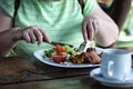 Woman in green dress eating lunch in cafe - image Royalty Free Stock Photo